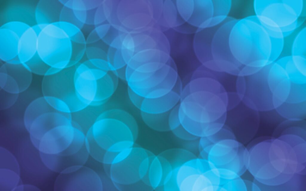 A vivid abstract bokeh background with blue and purple lights, perfect for design use.